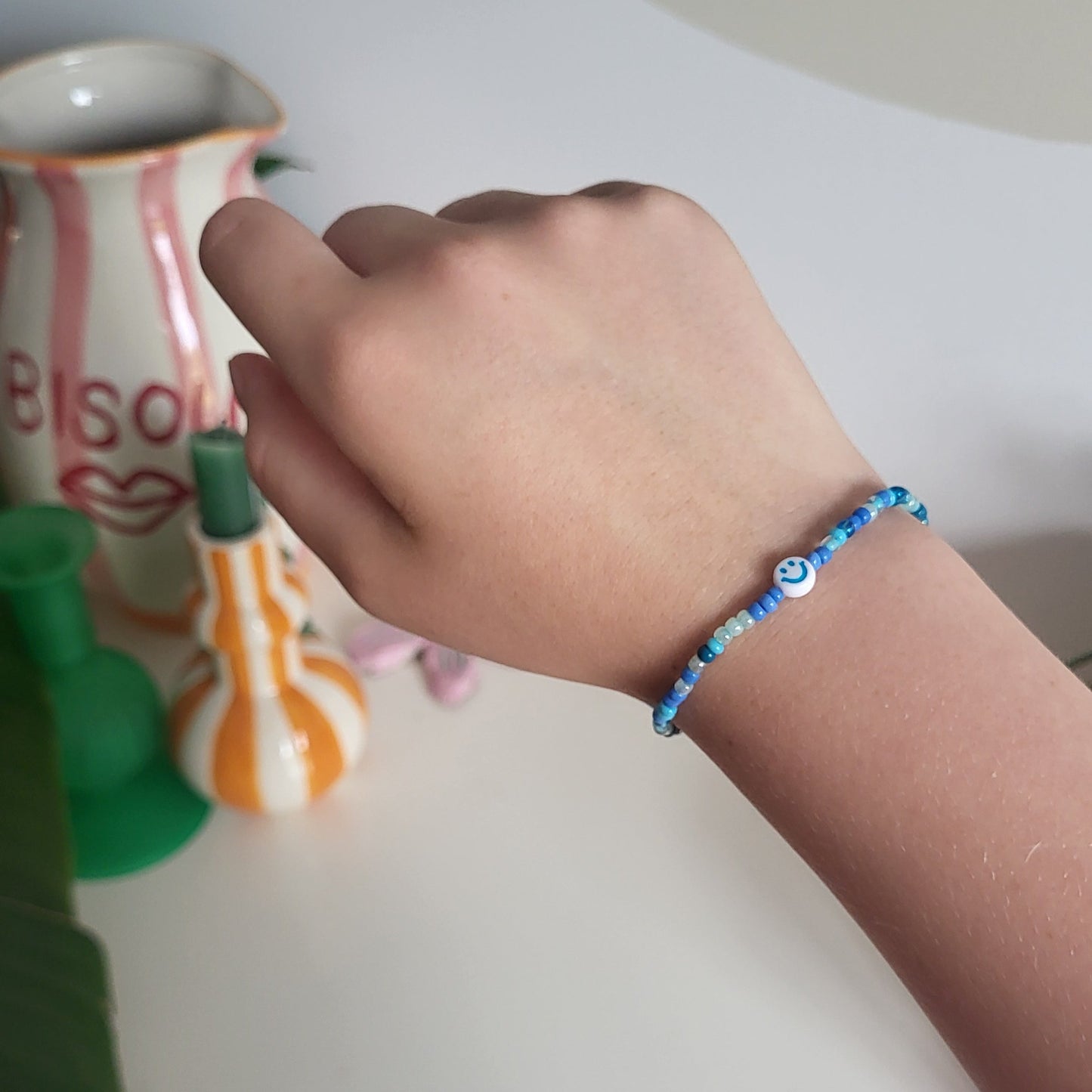 Blue bracelet with smiley charm